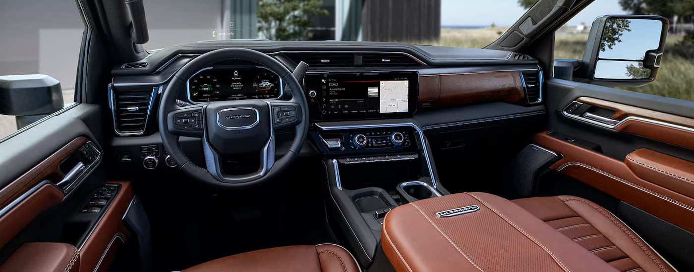 Interior view of a 2026 GMC Sierra 2500 HD infotainment and steering wheel.