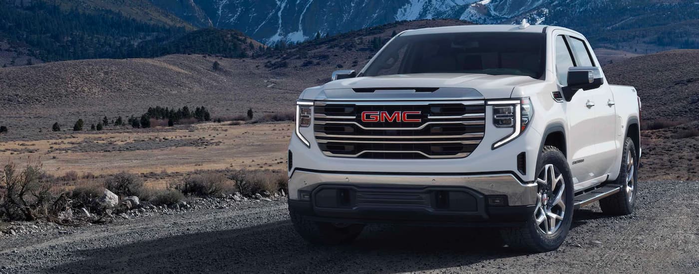 White 2023 GMC Sierra 1500 parked off-road.