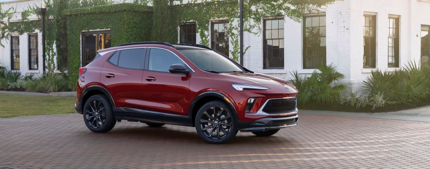 Side of a red 2026 Buick Encore GX parked on a driveway.