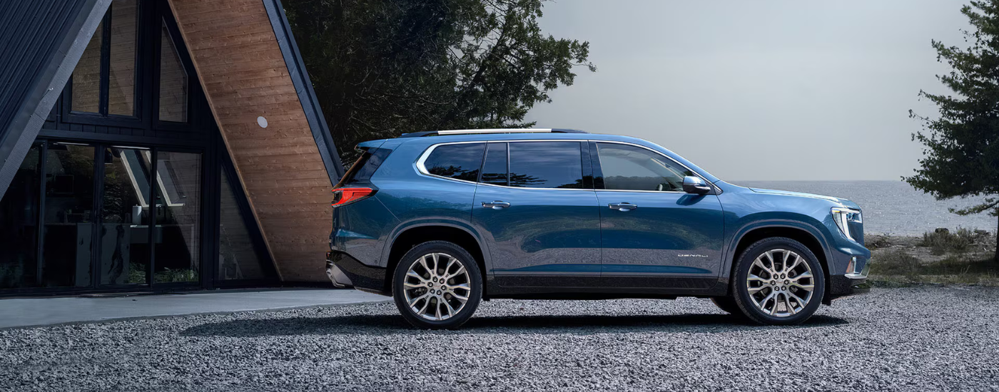 Blue 2026 GMC Acadia Denali parked in a driveway