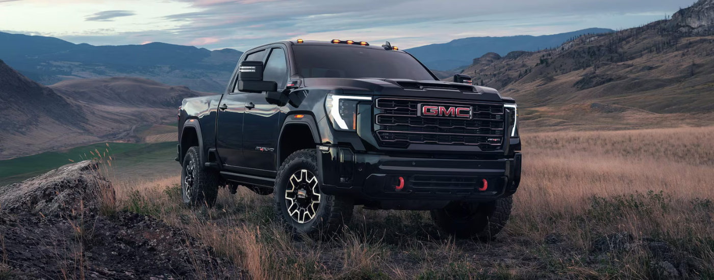Black 2026 GMC Sierra 2500 HD parked off-road