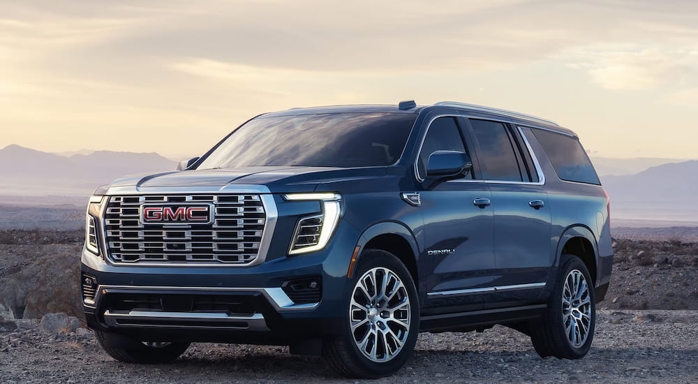 Blue 2027 GMC Yukon parked off-road.