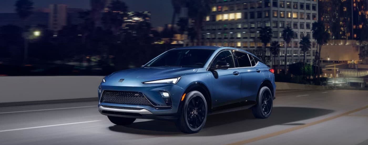 A blue 2026 Buick Envista driving in a city.