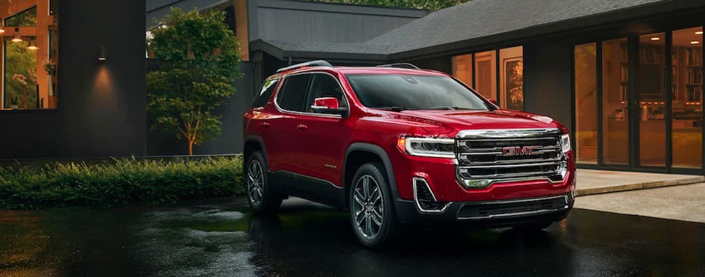 A red 2023 used GMC Acadia for sale near Troy from the front at an angle.