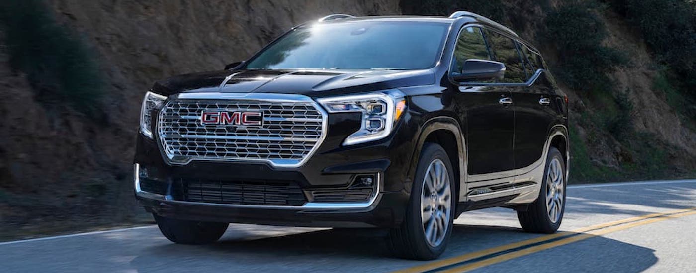 A black 2023 GMC Terrain from the front after leaving a dealer that has a used GMC for sale.
