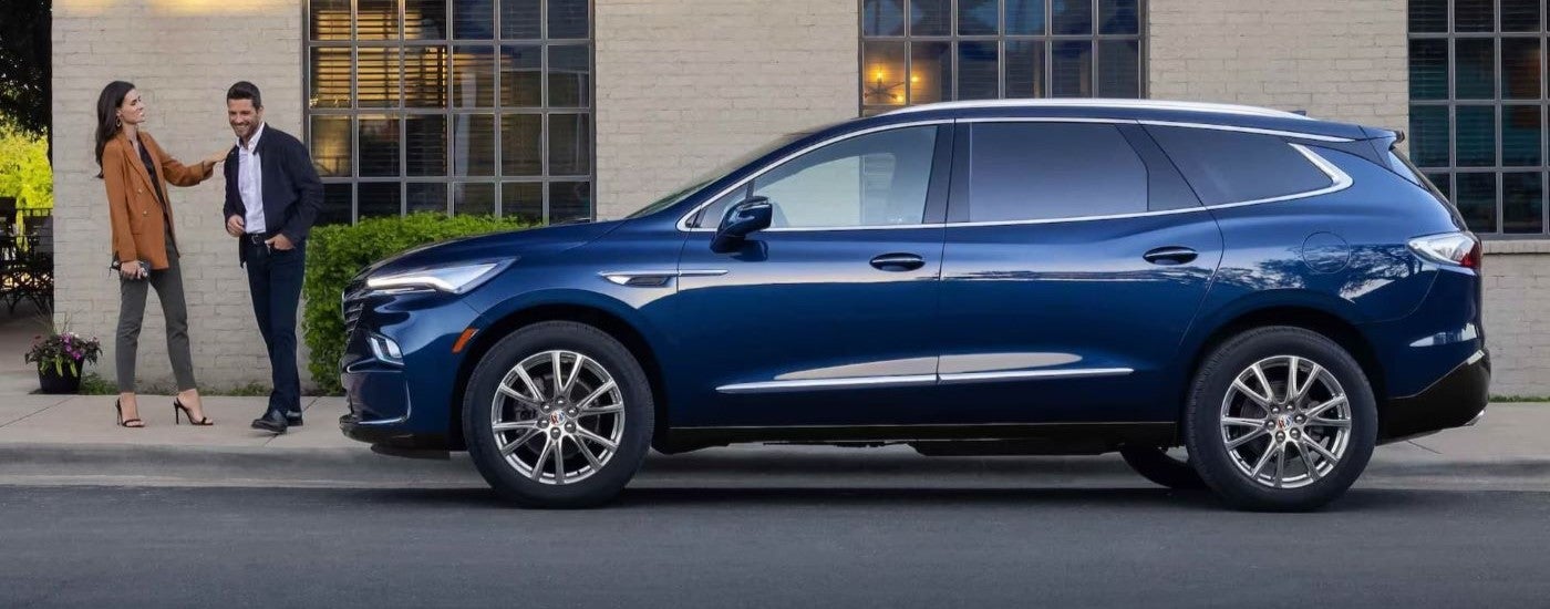 A blue 2023 Buick Enclave parked in a city