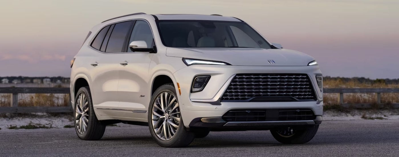 A silver 2025 Buick Enclave Avenir parked from a dealer near Ozark