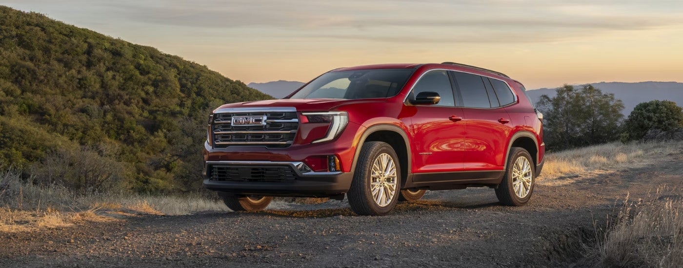 A red 2025 GMC Acadia parked from a dealer near Ozark