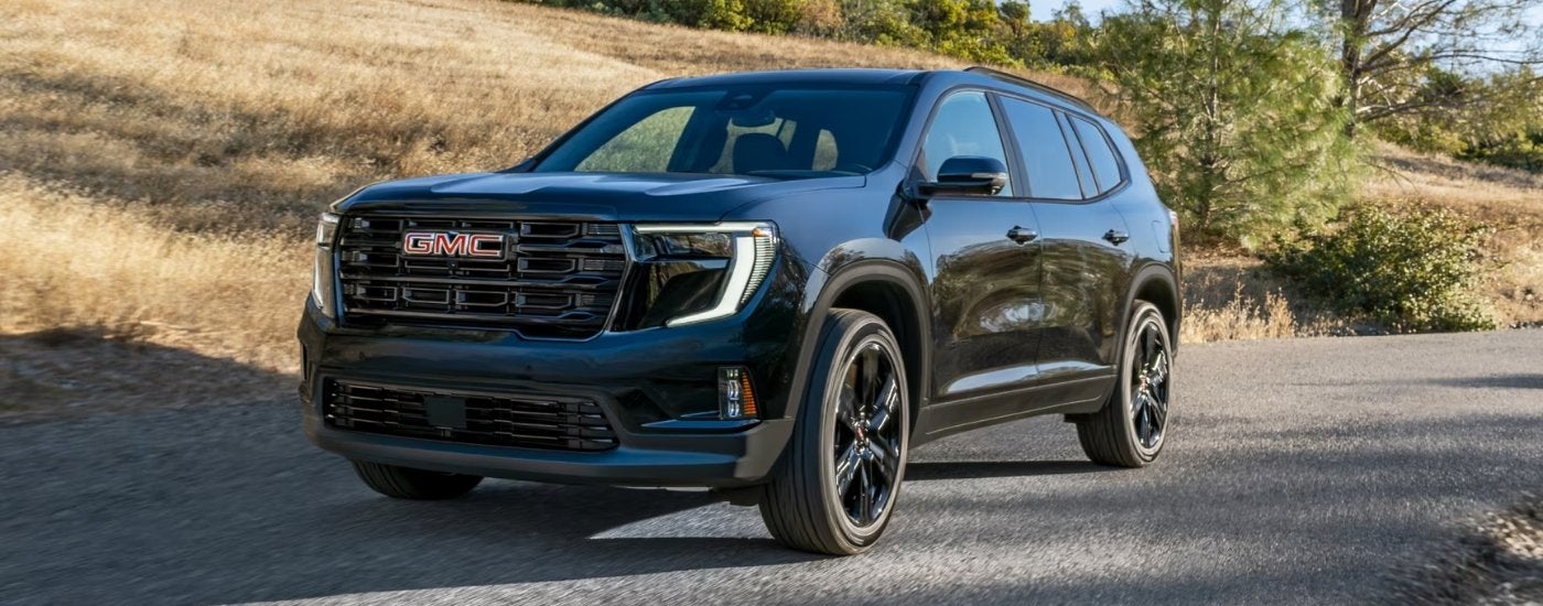 A black 2025 GMC Acadia Elevation parked off-road