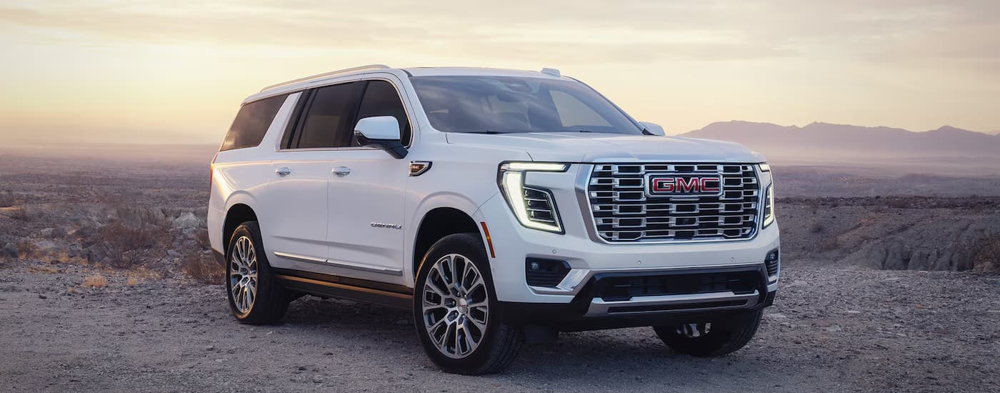 A white 2026 GMC Yukon Denali parked off-road