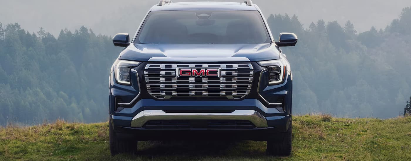 A blue 2025 GMC Terrain Denali parked off-road